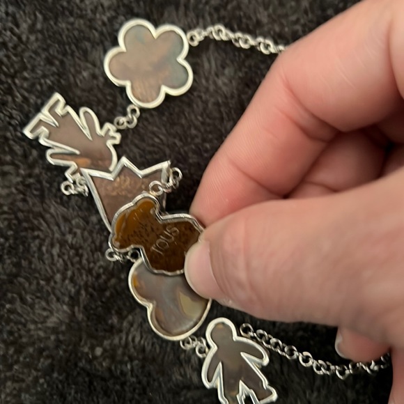 Tous Accessories - Tous necklace, Brown marble Tous with a heart a flower and a boy and a girl.